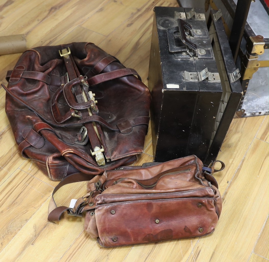 A large brown leather Gladstone bag, a Bally Italian brown leather satchel bag and a compatmental suitcase